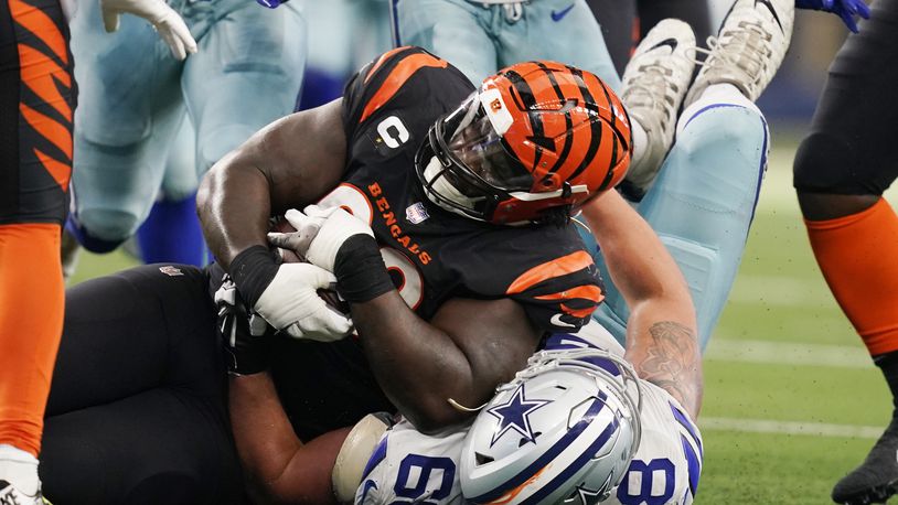 Cincinnati Bengals defensive tackle DJ Reader (98) protects the ball after a fumble recovery as Dallas Cowboys guard Matt Farniok (68) makes the stop during the second half of an NFL football game Sunday, Sept. 18, 2022, in Arlington, Tx. (AP Photo/Tony Gutierrez)