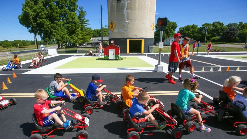 Children learn about road rules during Safety Town this week at Officer Bob Gentry Park in Hamilton. GREG LYNCH / STAFF
