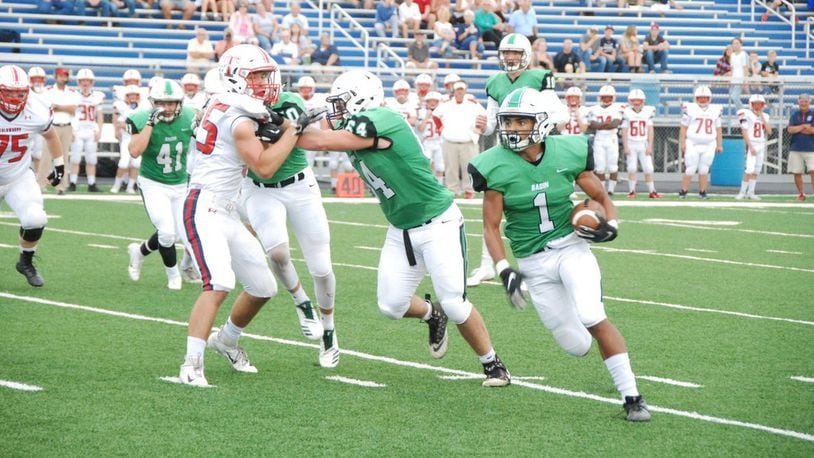 Badin’s Davon Starks (1) gets a block from teammate Andrew Jones last Friday night against Talawanda at Hamilton’s Virgil Schwarm Stadium. Inclement weather forced the game to be completed at Talawanda on Saturday, with Badin winning 38-7. CONTRIBUTED PHOTO BY OLIVER SANDERS