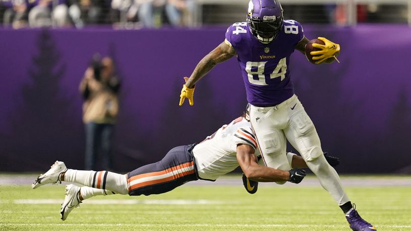 Minnesota Vikings tight end Irv Smith Jr. (84) is tackled by Chicago Bears cornerback Kyler Gordon, left, after catching a pass during the second half of an NFL football game, Sunday, Oct. 9, 2022, in Minneapolis. (AP Photo/Abbie Parr)