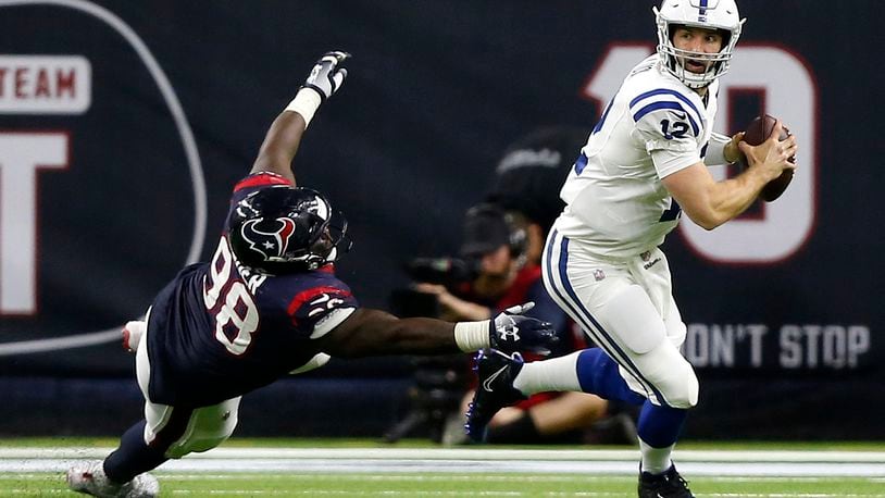 HOUSTON, TX - JANUARY 05: Andrew Luck #12 of the Indianapolis Colts avoids the tackle attempt by D.J. Reader #98 of the Houston Texans during the third quarter during the Wild Card Round at NRG Stadium on January 5, 2019 in Houston, Texas. (Photo by Bob Levey/Getty Images)