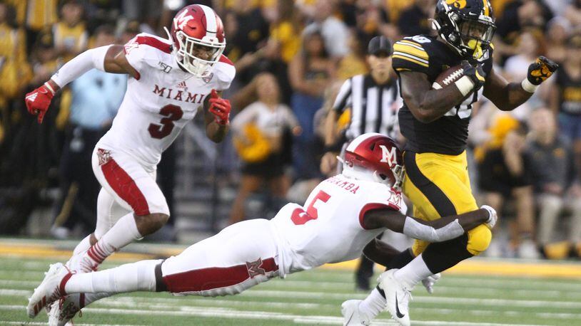IOWA CITY, IOWA- AUGUST 31:  Running back Mekhi Sargent #10 of the Iowa Hawkeyes is brought down in the first half in by defensive back Emmanuel Rugamba #5 of the Miami Ohio RedHawks on August 31, 2019 at Kinnick Stadium in Iowa City, Iowa.  (Photo by Matthew Holst/Getty Images)