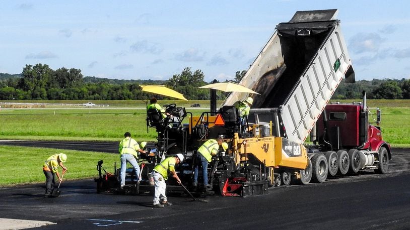 Crews pave sections of the taxiway during a resurfacing project at Middletown Regional Airport Friday, Aug. 18, in Middletown. NICK GRAHAM/STAFF