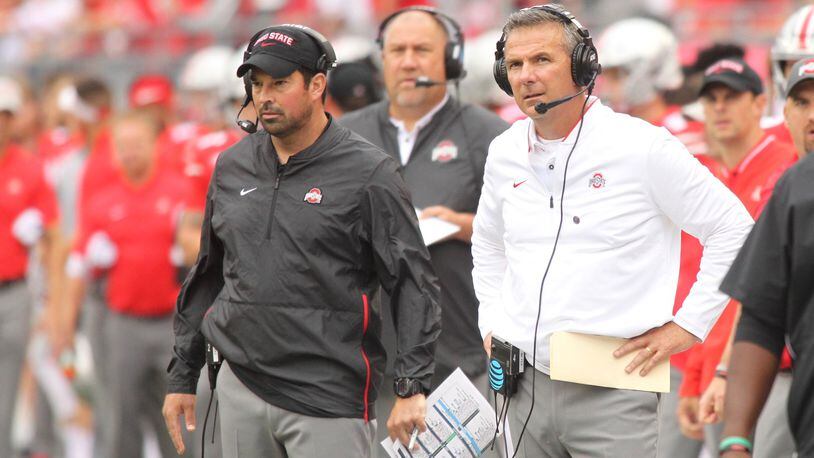 Ohio State’s Ryan Day, left, and Urban Meyer watch the action during a game against Tulane on Saturday, Sept. 22, 2018, at Ohio Stadium in Columbus. David Jablonski/Staff