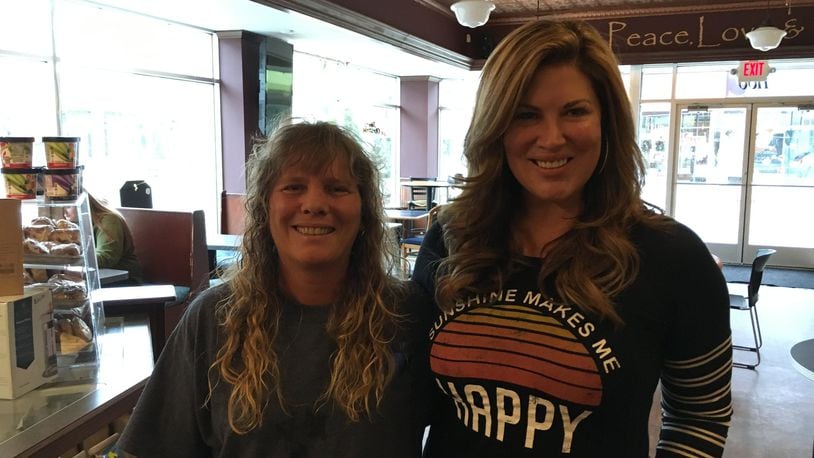Heather Gibson of the Triple Moon Coffee Company poses with Emily Simpson, right, of “The Real Housewives of Orange County” reality show recently at the Triple Moon Coffee Company. A native of Madison Twp., Simpson returns to the area to visit friends and family. ED RICHTER/STAFF