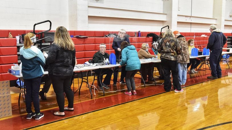 Madison Local Schools voters will choose to of the three candidates seeking election on Nov. 2. Pictured are voters in November 2020 at Madison schools' auxiliary gymnasium. NICK GRAHAM/FILE