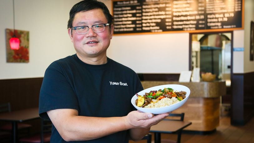 John Chen, owner of Yummy Bowl, hold one of thier most popular dishes, the Sichuan Sizzling Beef.