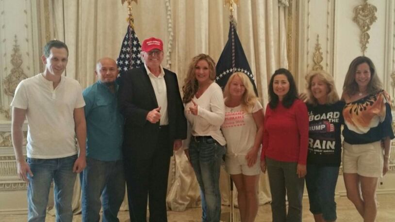 President Donald Trump poses with seven supporters who were scooped up off Bingham Island by the Secret Service on for an impromptu visit with the president on Saturday, March 18, 2017. Brett Borders (far left), Ronald Zuniga (to Trump’s immediate right) and Valeria Bianco (far right) returned to Bingham Island on Sunday to bid the president farewell.