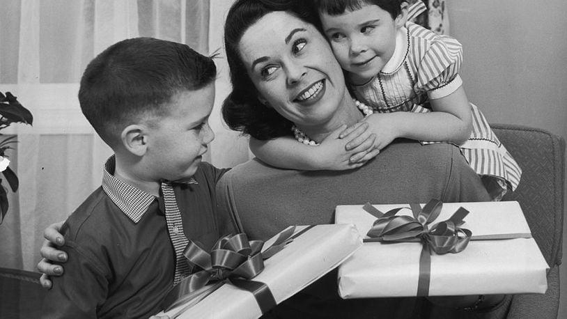 circa 1955:  A boy and girl give presents to their mother on Mother's Day.  (Photo by Lambert/Getty Images)