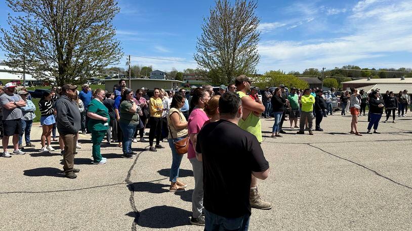 People wait for their children outside the Mount Horeb School District bus station in Mount Horeb, Wis., where students were taken after an active shooter situation at the middle school, Wednesday, May 1, 2024. Authorities said without giving details that the “alleged assailant” was harmed, and a witness said she had heard gunshots and saw dozens of children running. (AP Photo/Todd Richmond)