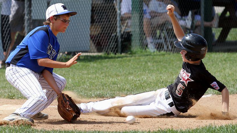 Hamilton third baseman Alex Mills gets the ball too late to make a play on Lebanon baserunner Jimmy Myers during their game at West Side Little League in Hamilton Saturday, July 13, 2013. CONTRIBUTED PHOTO BY E.L. HUBBARD