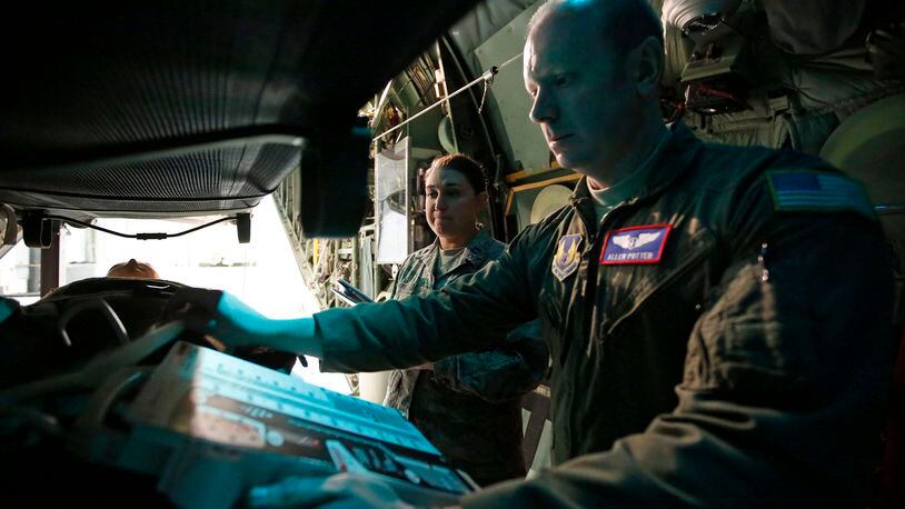 Flight nursing student Capt. Shauntel Haas, left, listens to flight nurse instructor Capt. Allen Potter as they train in the back of a C-130 Hercules at Wright-Patterson Air Force Base in early 2017. Military personnel at the base received aeromedical evacuation training with hands-on simulation techniques. TY GREENLEES / STAFF