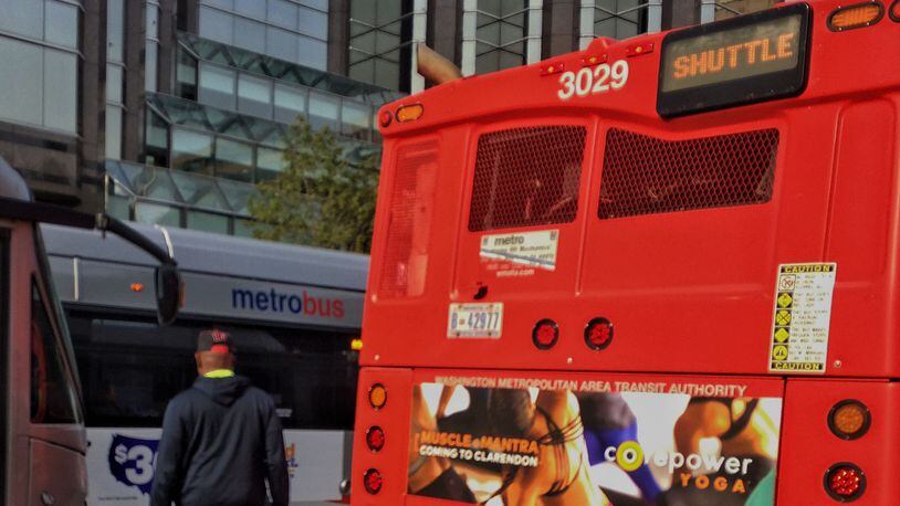 A person was seen holding on to the back of a Metrobus in Washington, D.C.