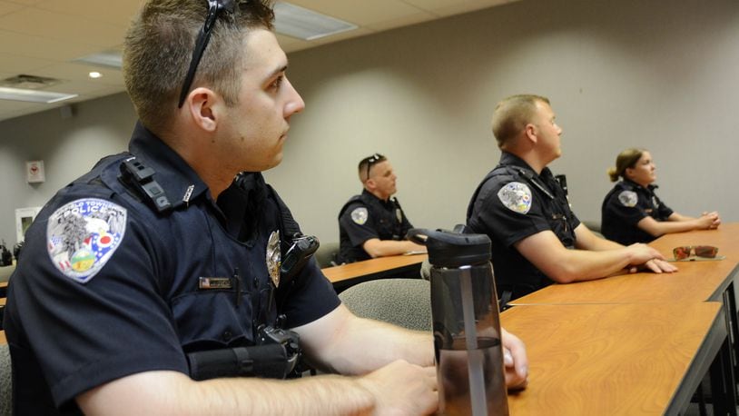 Fairfield Twp. police Officer John Boyer sits with other officers in the daily briefing on July 3, 2019, before the start of the second shift. Many departments around the region are bringing on younger officers as older officers leave or retire. MICHAEL D. PITMAN/STAFF