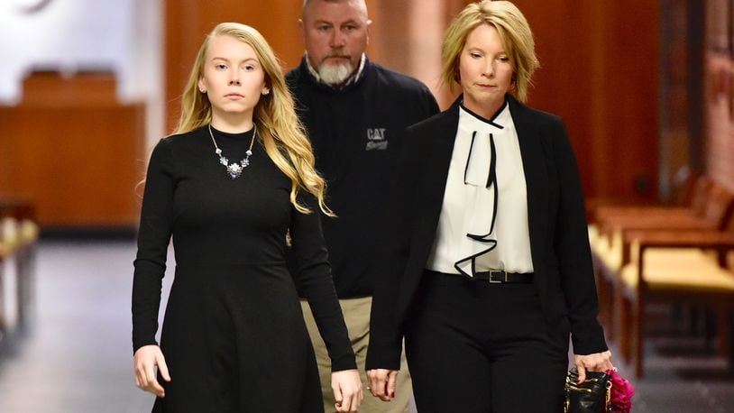 Brooke Skylar Richardson, left, arrives for a hearing today in Warren County Common Pleas Court with her parents Scott and Kimberly Richardson. The teen is charged with aggravated murder and other felonies for allegedly killing her infant and burying it in the back yard. NICK GRAHAM/STAFF