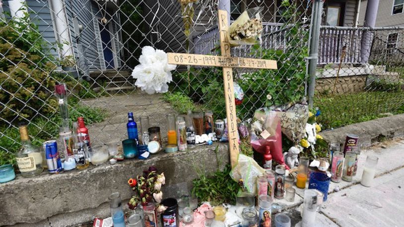 The memorial on East Avenue for Shon Walker who was shot and killed July 2y has grown. NICK GRAHAM/STAFF