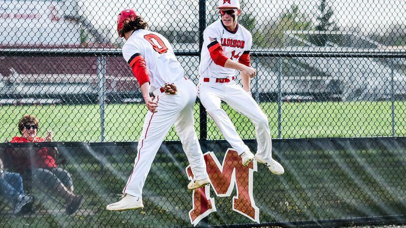 Madison’s Reid Davis (0) jumps to celebrate his run with Noah Lehman (14) during their game against Carlisle on April 26 at Madison. NICK GRAHAM/STAFF