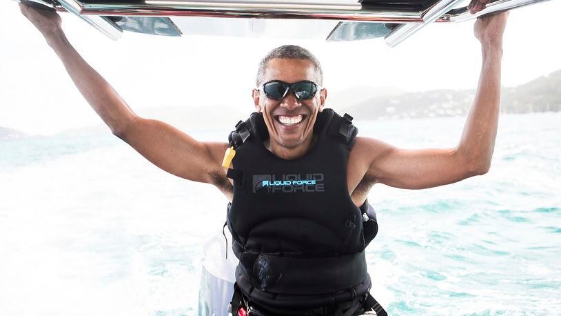 In this recent but undated photo made available by Virgin.com, former U.S President Barack Obama prepares to kitesurf during his stay on Moskito Island, British Virgin Islands. The former president and his wife stayed on Mosikto Island owned by Richard Branson, founder of the Virgin Group, after he finished his second term as President and left the White House. (Jack Brockway/Virgin.com via AP)