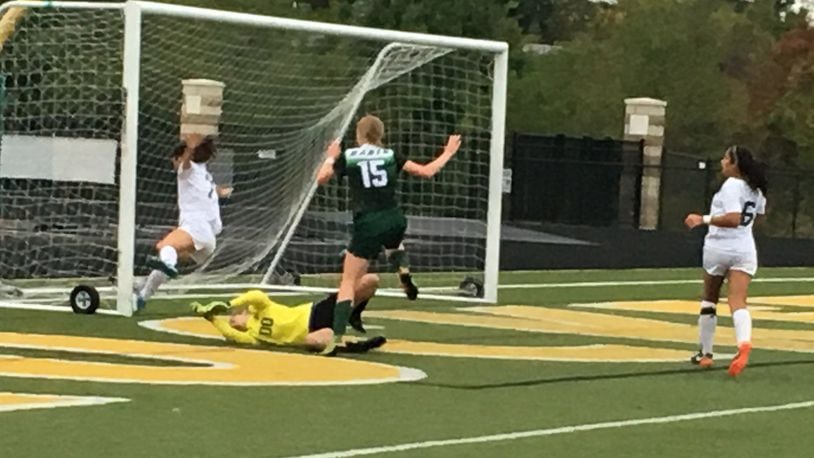 Badin’s Gabi Reising (15) has her scoring attempt denied by goalkeeper Maddie Kouche and Claire Dotson (7) of McNicholas as the Rockets’ Maria Randolph (6) trails the play Wednesday night at Penn Station Stadium in Cincinnati. RICK CASSANO/STAFF