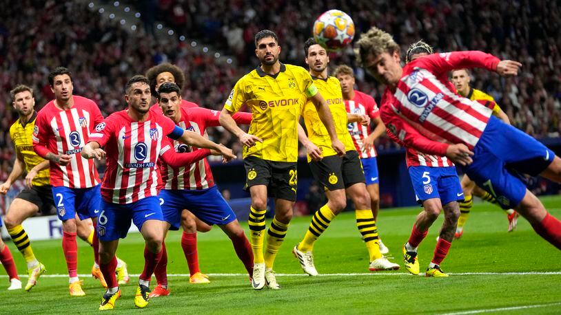 Atletico Madrid's Antoine Griezmann, right, heads the ball during the Champions League quarterfinal soccer match between Atletico Madrid and Borussia Dortmund at the Metropolitano stadium in Madrid, Spain, Wednesday, April 10, 2024. (AP Photo/Manu Fernandez)