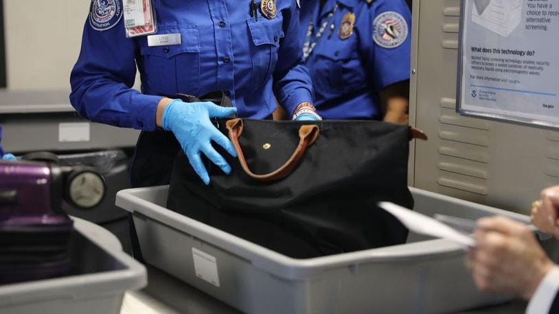 A Transportation Security Administration (TSA) worker screens luggage.