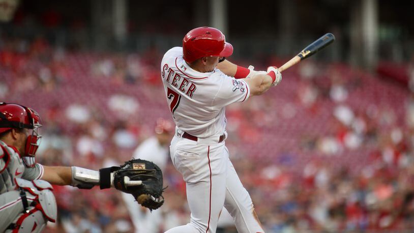 Spencer Steer, of the Reds, singles to drive in a run in the third inning against the Phillies on Thursday, April 13, 2023, at Great American Ball Park in Cincinnati. David Jablonski/Staff