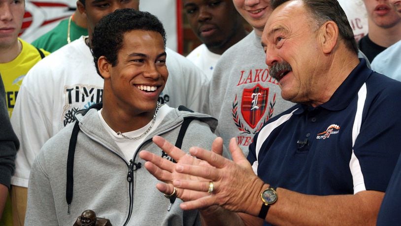 Lakota West High School senior Jordan Hicks talks with former Chicago Bearslinebacker Dick Butkus after receiving the Dick Butkus Award for being the top prep linebacker in the country Dec. 9, 2009, at Lakota West. COX MEDIA FILE PHOTO