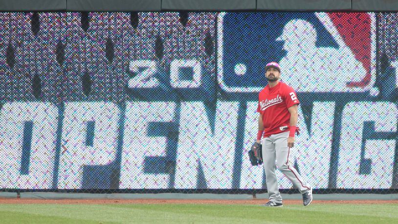 Nationals left fielder Adam Eaton patrols the outfield during batting practice before a game against the Reds on Opening Day on Friday, March 30, 2018, at Great American Ball Park in Cincinnati. David Jablonski/Staff