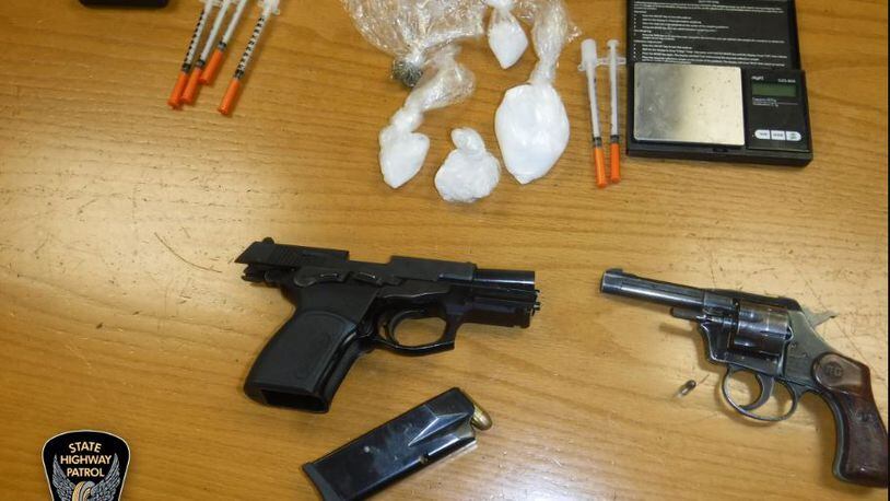 Drugs, needles and a pair of loaded handguns were seized during a traffic stop in Middletown by Ohio Highway Patrol troopers. CONTRIBUTED