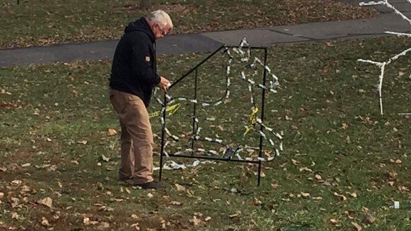 Don Owens, a retired Middletown police lieutenant and a member of the Grandpa Gang, was checking the wiring and bulbs of one of the many displays for Light Up Middletown on Tuesday. ED RICHTER/STAFF