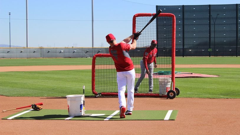 Former Reds shortstop Barry Larkin works with right fielder Jay Bruce at the team’s spring training complex on Wednesday, Feb. 24 in Goodyear, Ariz. Staff photo/Mike Hartsock