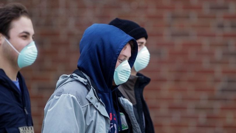 Miami University students wear masks at the main campus in Oxford Jan. 28, 2020, after administrators announced two students are in isolation and were tested for possible novel coronavirus infection.