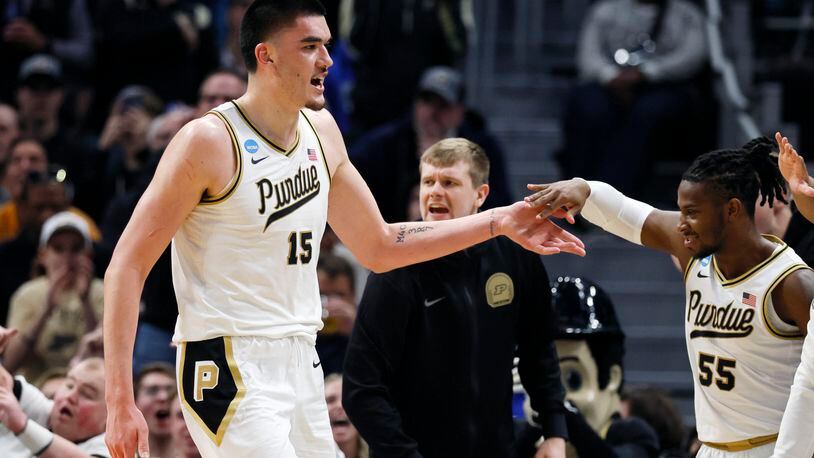 Purdue center Zach Edey (15) is greeted by guard Lance Jones (55) as he heads to the bench during the second half of a Sweet 16 college basketball game against Gonzaga in the NCAA Tournament, Friday, March 29, 2024, in Detroit. (AP Photo/Duane Burleson)