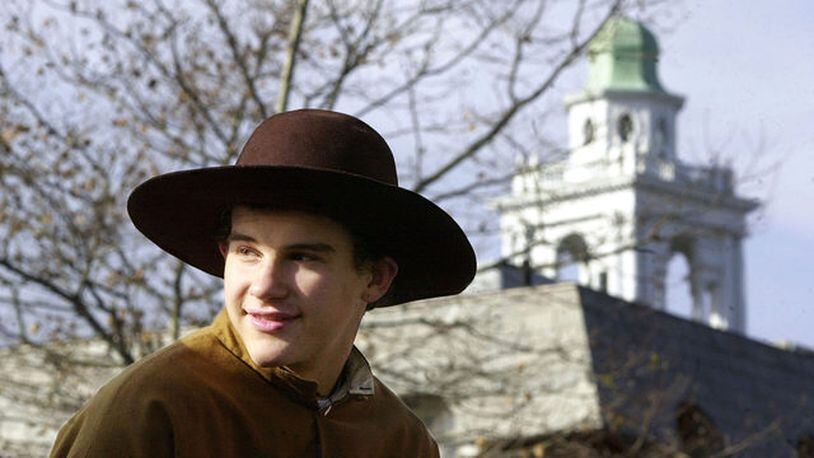 PLYMOUTH, MA - NOVEMBER 20: A boy dressed as a pilgrim rides on a float during the annual Thanksgiving Parade November 20, 2004 in Plymouth, Massachusetts.