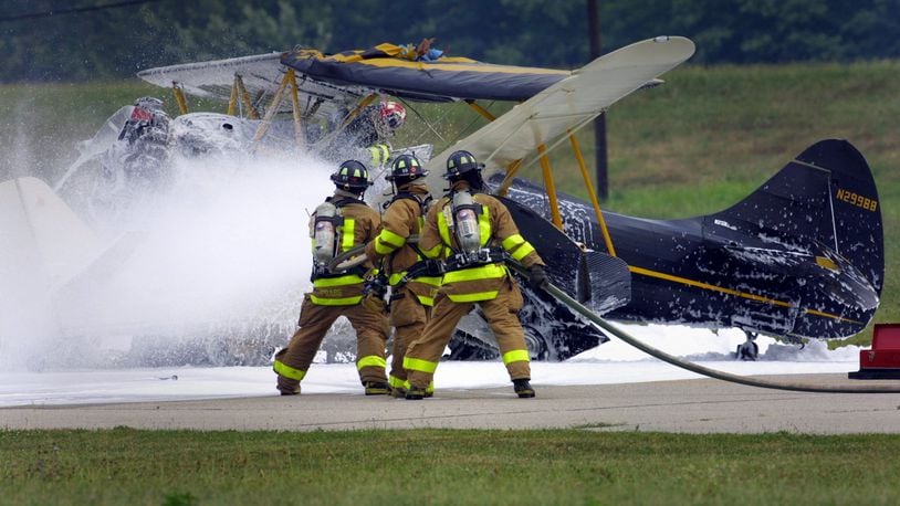 Firefighters work on the scene of a two plane collision on the runway at Moraine Air Park in 2002. White fire retardant foam was sprayed on the planes and the surrounding area. Firefighting foams are under scrutiny because many contain PFAS chemicals. Two sites where PFAS has been used in firefighting foam, Wright-Patterson Air Force Base and Dayton's fire training center, sit above the aquifer. STAFF FILE
