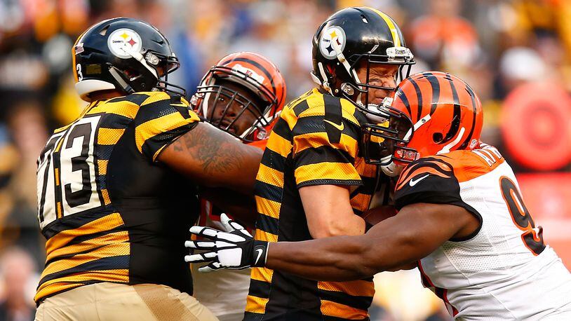 Bengals defensive tackle Geno Atkins, seen here mashing Steelers quarterback Ben Roethlisberger in a 2015 game in Pittsburgh, made the All-AFC North team for defensive players and special teams players. He was joined by end Carlos Dunlap and cornerback Adam Jones, while wide receiver A.J. Green and tight end Tyler Eifert made the offensive squad.