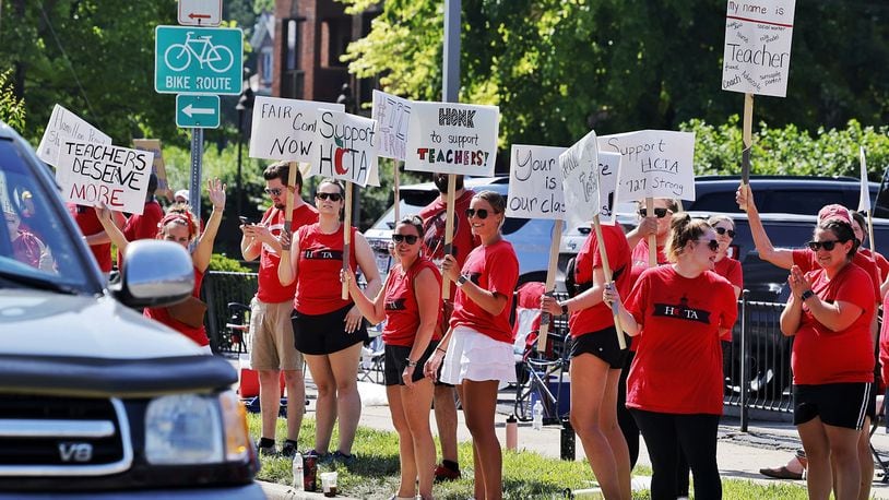 Hamilton teachers gathered along Dayton Street in front of the Hamilton City School District building to demonstrate for fair pay for teachers Wednesday, June 22, 2022. NICK GRAHAM/STAFF