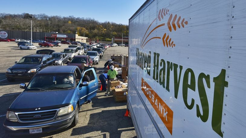 More than 100 cars lined up in Hamilton Friday to receive free food boxes as part of senior program sponsored by Shared Harvest food bank in Fairfield. More than 300 seniors who had signed up for the food giveaway came through the distribution center set up in a shopping center parking lot along Route 4 in Hamilton. (Photo By Nick Graham\Journal-News)