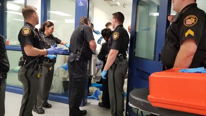 Corrections officers at the Butler County Jail stand-by as another officer and the jail medic helps to deliver a baby girl. The mother is an inmate at the jail. CONTRIBUTED PHOTO/BUTLER COUNTY SHERIFF’S OFFICE
