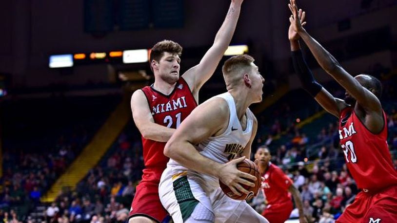 Wright State’s Loudon Love is defended by Miami’s Aleks Abrams (21) and Abdoulaye Harouna at the Nutter Center on Wednesday, Dec. 5, 2018. Joseph Craven/CONTRIBUTED