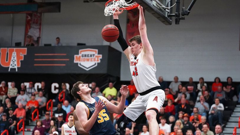 The University of Findlay’s Alex White gets a dunk March 8 during an 80-77 win over visiting Cedarville in a Great Midwest Athletic Conference tournament semifinal. PHOTO COURTESY OF FINDLAY ATHLETICS