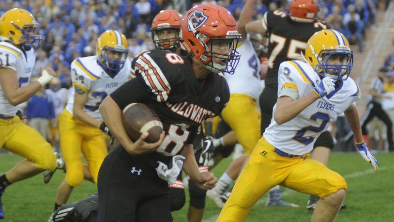 Coldwater quarterback Sam Broering outraces Marion Local’s Tyler Prenger (2) for a 40-yard touchdown Sept. 8 at Coldwater. The host Flyers won 13-7. MARC PENDLETON/STAFF
