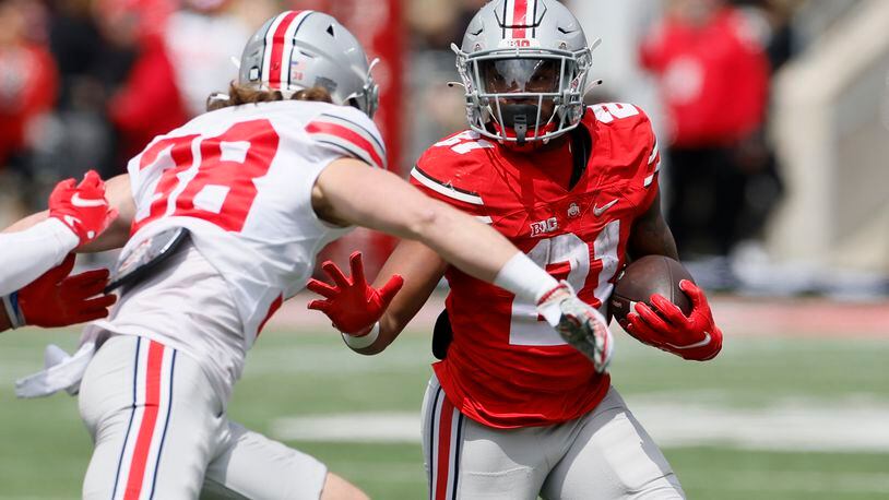 Ohio State running back Evan Pryor, right, runs after a catch as defensive back Cameron Kittle defends during an NCAA college spring football game Saturday, April 16, 2022, in Columbus, Ohio. (AP Photo/Jay LaPrete)