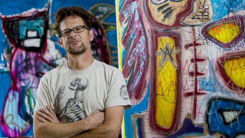 Former Metallica bassist Jason Newsted stands with two of his art pieces at his home in Jupiter on November 13, 2017. (Photo: Richard Graulich / The Palm Beach Post)