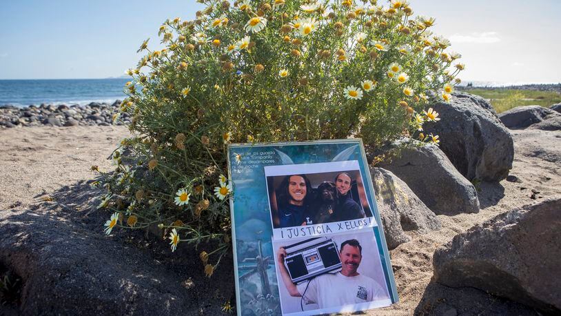 The photos of the foreign surfers who disappeared are placed on the beach in Ensenada, Mexico, Sunday, May 5, 2024. Mexican authorities said Friday that three bodies were recovered in an area of Baja California near where two Australians and an American went missing last weekend during an apparent camping and surfing trip. (AP Photo/Karen Castaneda)