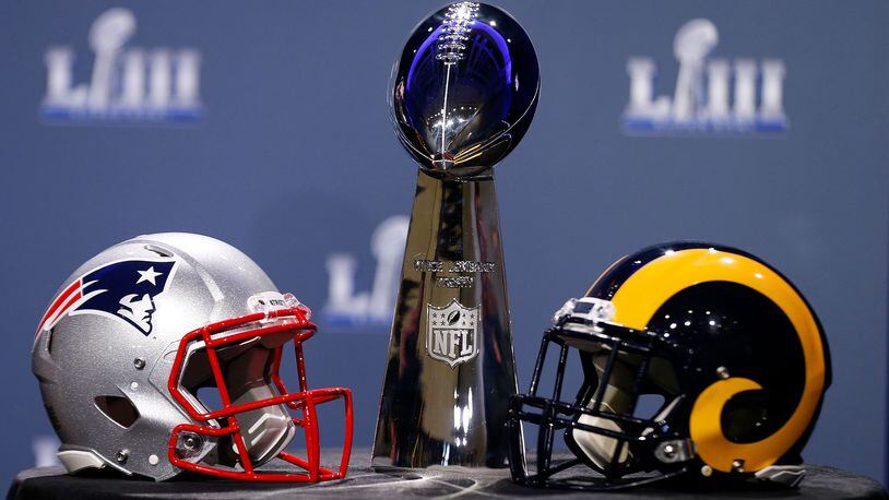 ATLANTA, GA - JANUARY 30:  Detail of the Lombardi Trophy and the helmets of the New England Patriots (left) and the Los Angeles Rams prior to NFL Commissioner Roger Goodell speaking during a press conference during Super Bowl LIII Week at the NFL Media Center inside the Georgia World Congress Center on January 30, 2019 in Atlanta, Georgia.  (Photo by Mike Zarrilli/Getty Images)