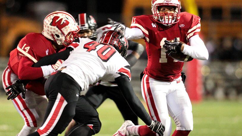 Lakota West’s Jarin Higginbotham (11) runs the ball during a game against visiting Oak Hills on Oct. 25, 2013. COX MEDIA FILE PHOTO