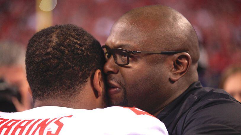 Ohio State running backs coach Tony Alford, right, hugs J.K. Dobbins after a victory against Wisconsin in the Big Ten Championship on Dec. 2, 2017, at Lucas Oil Stadium in Indianapolis. David Jablonski/Staff