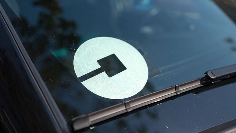 Logo for car-sharing company Uber on the passenger side windshield of a vehicle on October 13, 2017.