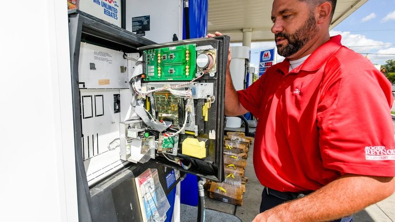 Tom Kamphaus, Consumer Services Director for Butler County Auditor’s Office, checks for credit card skimmers at the Marathon gas station at the corner of Cincinnati Dayton Road and Tylersville Road Thursday, Sept. 1, 2016 in West Chester Township. NICK GRAHAM/STAFF
